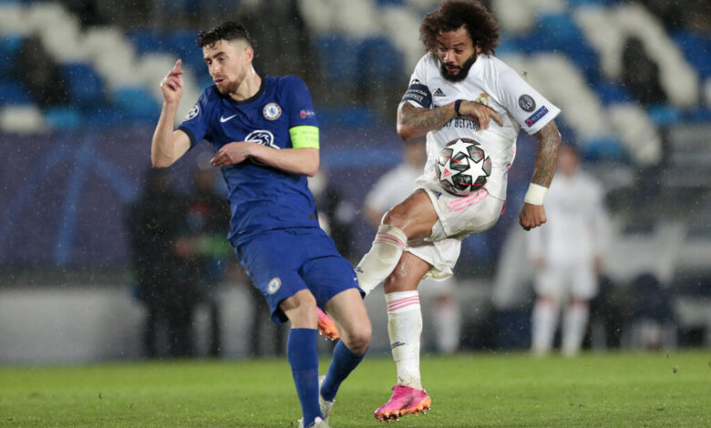 Real Madrid's Marcelo vies for the ball with Chelsea's Jorginho, left, during the Champions League semifinal first leg soccer match between Real Madrid and Chelsea at the Alfredo di Stefano stadium in Madrid, Spain, Tuesday, April 27, 2021. (AP Photo/Bernat Armangue)