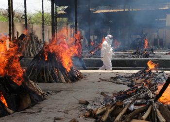 Multiple funeral pyres of people who died of COVID-19 burn at the Ghazipur crematorium in New Delhi, India, Thursday, May 13, 2021. (AP Photo/Amit Sharma)