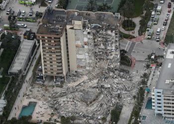 This aerial photo shows part of the 12-story oceanfront Champlain Towers South Condo that collapsed early Thursday, June 24, 2021 in Surfside, Fla.  (Amy Beth Bennett/South Florida Sun-Sentinel via AP)