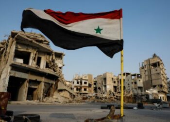 Syrian flag flutters at a military check point in al-Khalidiya area, in the government-controlled part of Homs, Syria, September 18, 2018. In the al-Khalidiya district of Homs, retaken by the government in 2013, after heavy army bombardment and air strikes, the slow nature of recovery is clear. Much of the neighbourhood is a ghost town, uninhabited and closed by the army. REUTERS/Marko Djurica      SEARCH "SYRIA LIFE" FOR THIS STORY. SEARCH "WIDER IMAGE" FOR ALL STORIES.