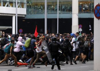 Riot policemen clash with protestors outside El Prat airport in Barcelona, Spain, Monday, Oct. 14, 2019. Riot police have charged at protesters outside Barcelona's airport after the Supreme Court sentenced 12 prominent Catalan separatists to lengthy prison terms for their roles in a 2017 push for the wealthy Spanish region's independence. (AP Photo/Emilio Morenatti) ORG XMIT: XAF127