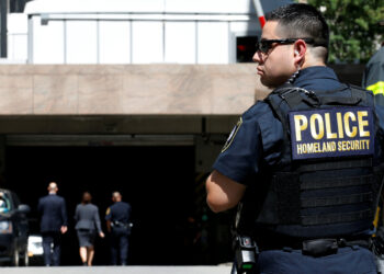 A Homeland Security officer stands in front of the parking garage of 26 Federal Plaza, following an incident where an FBI Agent was injured, in New York City, U.S., August 16, 2017. REUTERS/Brendan McDermid