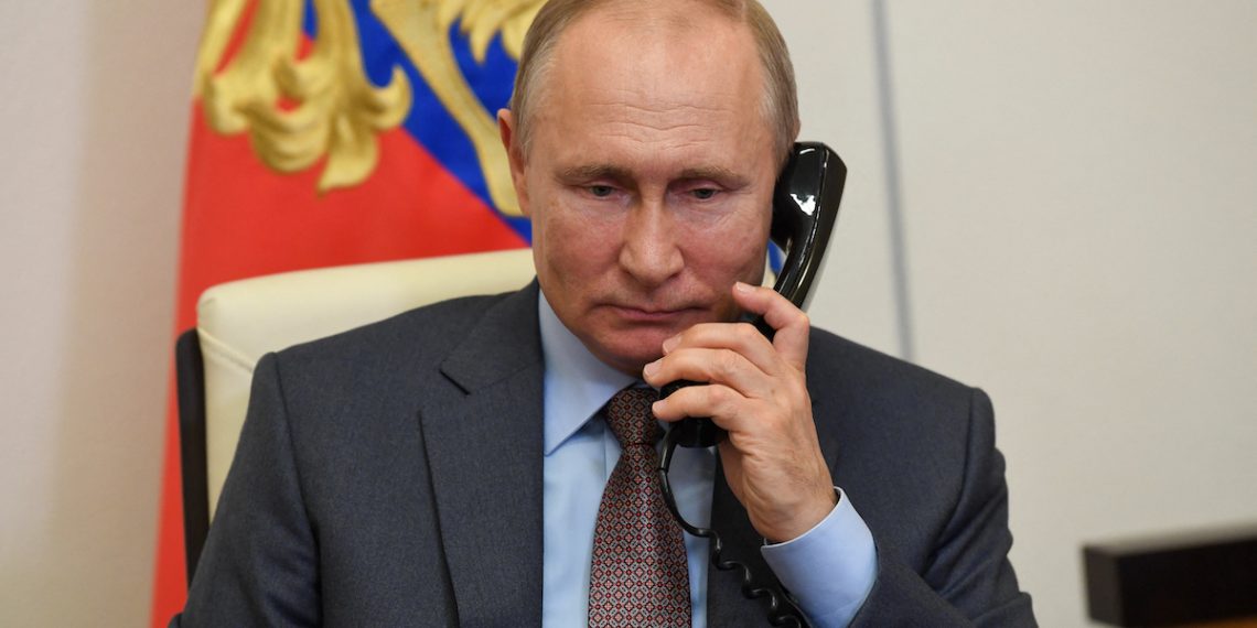 Russian President Vladimir Putin listens to Russian Prime Minister Mikhail Mishustin during their teleconference meeting on Russia's economy recovery at Novo-Ogaryovo state residence, outside Moscow, on June 2, 2020. - Russia plans to spend about USD 72 billion (65 billion euro) on a plan to restore the economy following the coronavirus shutdown, Prime Minister Mikhail Mishustin said. (Photo by - / various sources / AFP)