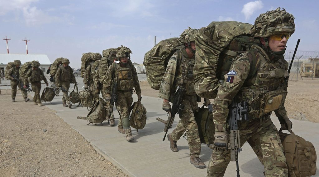 British troops prepare to depart upon the end of operations for U.S. Marines and British combat troops in Helmand October 27, 2014. A fleet of planes and helicopters airlifted the last U.S. and British forces from a key base in southern Afghanistan on Monday, a day after the international coalition closed the massive facility and handed it over to the Afghan military. REUTERS/Omar Sobhani (AFGHANISTAN - Tags: MILITARY CONFLICT POLITICS) - RTR4BR8C