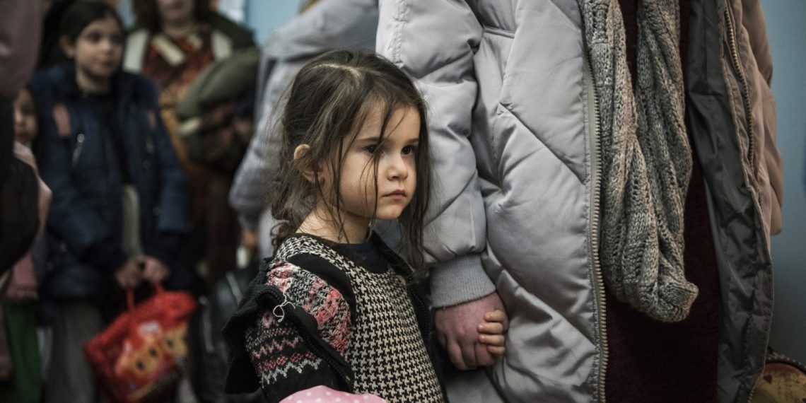 Children and their companions from an orphanage in Odesa, Ukraine, wait for room allocation after their arrival at a hotel in Berlin, Friday, March 4, 2022. More than 100 Jewish refugee children who were evacuated from a foster care home in war-torn Ukraine and made their way across Europe by bus have arrived in Berlin. (AP Photo/Steffi Loos)