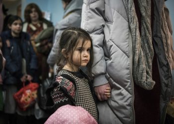 Children and their companions from an orphanage in Odesa, Ukraine, wait for room allocation after their arrival at a hotel in Berlin, Friday, March 4, 2022. More than 100 Jewish refugee children who were evacuated from a foster care home in war-torn Ukraine and made their way across Europe by bus have arrived in Berlin. (AP Photo/Steffi Loos)