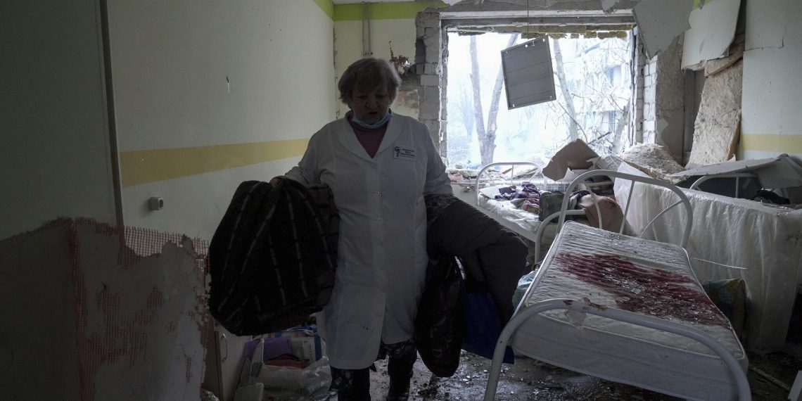 A medical worker walks inside of the damaged by shelling maternity hospital in Mariupol, Ukraine, Wednesday, March 9, 2022. A Russian attack has severely damaged a maternity hospital in the besieged port city of Mariupol, Ukrainian officials say. (AP Photo/Evgeniy Maloletka)