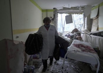 A medical worker walks inside of the damaged by shelling maternity hospital in Mariupol, Ukraine, Wednesday, March 9, 2022. A Russian attack has severely damaged a maternity hospital in the besieged port city of Mariupol, Ukrainian officials say. (AP Photo/Evgeniy Maloletka)