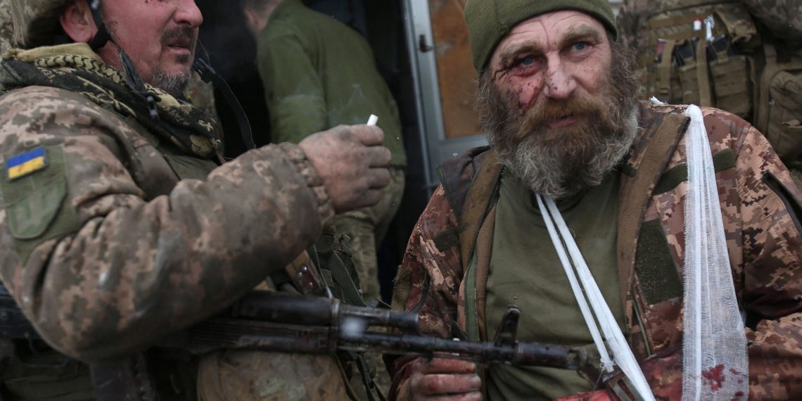 TOPSHOT - A wounded servicemen of Ukrainian Military Forces looks on after the battle with Russian troops and Russia-backed separatists in Lugansk region on March 8, 2022. - The number of refugees flooding across Ukraine's borders to escape towns devastated by shelling and air strikes passed two million, in Europe's fastest-growing refugee crisis since World War II, according to the United Nations. (Photo by Anatolii Stepanov / AFP) (Photo by ANATOLII STEPANOV/AFP via Getty Images)