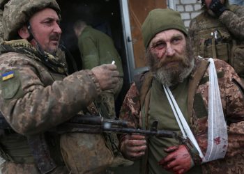 TOPSHOT - A wounded servicemen of Ukrainian Military Forces looks on after the battle with Russian troops and Russia-backed separatists in Lugansk region on March 8, 2022. - The number of refugees flooding across Ukraine's borders to escape towns devastated by shelling and air strikes passed two million, in Europe's fastest-growing refugee crisis since World War II, according to the United Nations. (Photo by Anatolii Stepanov / AFP) (Photo by ANATOLII STEPANOV/AFP via Getty Images)