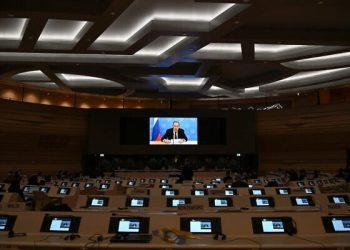 Russia's foreign minister Sergei Lavrov addresses with a pre-recorded video message the Conference on Disarmament in Geneva on March 1, 2022. - Ukraine's ambassador and diplomats from a wide number of countries staged a walkout Tuesday as Russia's foreign minister addressed the Conference on Disarmament in Geneva. The diplomats got up and left the room when Sergei Lavrov's pre-recorded video message began to play, in protest against Moscow's invasion of Ukraine. (Photo by Fabrice COFFRINI / POOL / AFP)