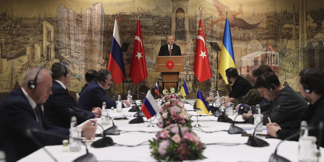 In this photo provided by Turkish Presidency, Turkish President Recep Tayyip Erdogan, center, gives a speech to welcome the Russian, left, and Ukrainian delegations ahead of their talks, in Istanbul, Turkey, Tuesday, March 29, 2022. The first face-to-face talks in two weeks between Russia and Ukraine were due to start Tuesday, raising flickering hopes of an end to a war that has ground into a bloody campaign of attrition. (Turkish Presidency via AP)