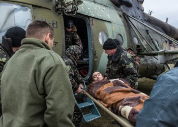 A wounded Ukrainian soldier is loaded onto a medevac helicopter on a sports field, which will take him and others to Dnipropetrovsk for treatment on February 8, 2015 in Artemivsk, Ukraine. Fighting between pro-Russia rebels and Ukrainian forces has dealt steady casualties to Ukrainian fighters and civilians.