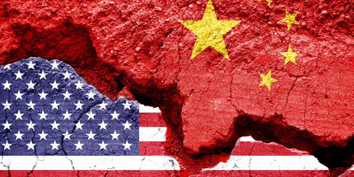 Flag of USA and China on a cracked background. Concept of crisis between two nations, Washington and Beijing