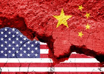 Flag of USA and China on a cracked background. Concept of crisis between two nations, Washington and Beijing