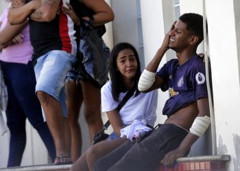 An injured person cries after being treated at Getulio Vargas Hospital after a police raid on the Vila Cruzeiro favela in Rio de Janeiro, Brazil, Tuesday, May 24, 2022. Police raided the favela before dawn Tuesday in an operation that prompted a fierce firefight and state officials said at least 11 people died. (AP Photo/Bruna Prado)