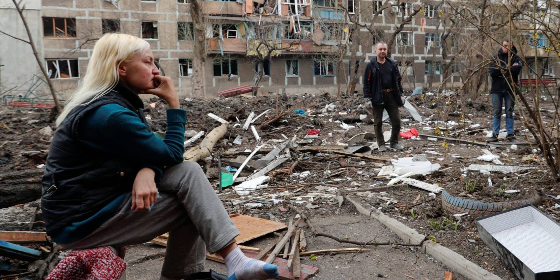 Local resident gather in a courtyard near a block of flats heavily damaged during Ukraine-Russia conflict in the southern port city of Mariupol, Ukraine April 18, 2022. REUTERS/Alexander Ermochenko