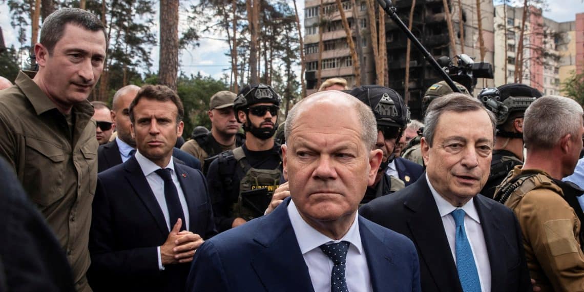 Ukrainian Minister for Communities and Territories Development Oleksiy Chernyshov walks next to French President Emmanuel Macron, German Chancellor Olaf Scholz, Italian Prime Minister Mario Draghi and Romanian President Klaus Iohannis during their visit, as Russia's attack on Ukraine continues, in Irpin, near Kyiv, Ukraine June 16, 2022.  REUTERS/Viacheslav Ratynskyi