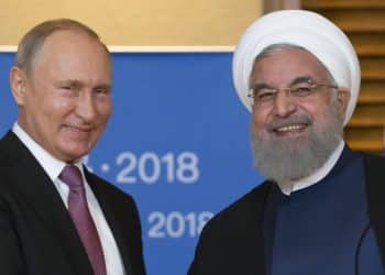 Russian President Vladimir Putin meets with Iranian President Hassan Rouhani on the sidelines of the Shanghai Cooperation Organisation (SCO) Summit in Qingdao on June 9, 2018. / AFP PHOTO / POOL / Alexander Zemlianichenko