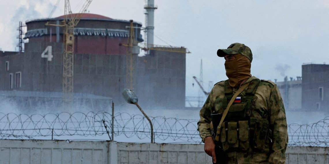 FILE PHOTO: A serviceman with a Russian flag on his uniform stands guard near the Zaporizhzhia Nuclear Power Plant in the course of Ukraine-Russia conflict outside the Russian-controlled city of Enerhodar in the Zaporizhzhia region, Ukraine August 4, 2022. REUTERS/Alexander Ermochenko/File Photo