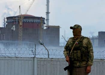 FILE PHOTO: A serviceman with a Russian flag on his uniform stands guard near the Zaporizhzhia Nuclear Power Plant in the course of Ukraine-Russia conflict outside the Russian-controlled city of Enerhodar in the Zaporizhzhia region, Ukraine August 4, 2022. REUTERS/Alexander Ermochenko/File Photo