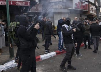 Palestinian gunmen fire weapons in the air during the funeral of Mohammad Abu Kushuk, 22 and Mohammad Herzallah, 30, in the West Bank city of Nablus, Thursday, Nov. 24, 2022. The two Palestinians succumbed to their wounds sustained during clashes with Israeli army forces during military operations in the occupied West Bank. (AP Photo/Nasser Nasser)