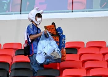 Soccer Football - FIFA World Cup Qatar 2022 - Group E - Japan v Costa Rica - Ahmad Bin Ali Stadium, Al Rayyan, Qatar - November 27, 2022 Japan fan cleans the stands after the match REUTERS/Dylan Martinez