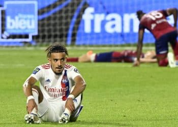 Lyon's French defender Malo Gusto (L) sits on the pitch at the end of the French L1 football match between Clermont Foot 63 and Olympique Lyonnais (OL) at Stade Gabriel Montpied in Clermont-Ferrand, central France on May 21, 2022. (Photo by THIERRY ZOCCOLAN / AFP) (Photo by THIERRY ZOCCOLAN/AFP via Getty Images)