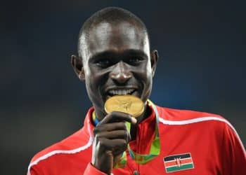 Gold medallist Kenya's David Lekuta Rudisha celebrates on the podium for the Men's 800 meter during the athletics at the Rio 2016 Olympic Games at the Olympic Stadium in Rio de Janeiro on August 16, 2016. (Photo by Johannes EISELE / AFP)