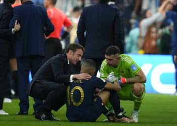 France's President Emmanuel Macron and goalkeeper Emiliano Martinez confort France's Kylian Mbappe at the end of the World Cup final soccer match between Argentina and France at the Lusail Stadium in Lusail, Qatar, Sunday, Dec. 18, 2022. (AP Photo/Natacha Pisarenko)