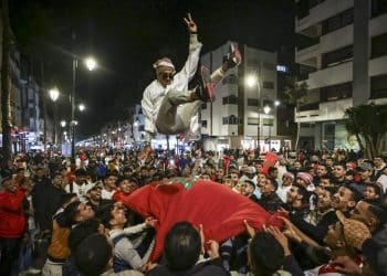 Morocco's supporters celebrate after their country's win of the Qatar 2022 World Cup football match between Morocco and Portugal, in the capital Rabat, on December 10, 2022. (Photo by FADEL SENNA / AFP)