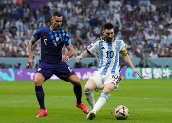 Argentina's Lionel Messi dribbles challenged by Croatia's Dejan Lovren during the World Cup semifinal soccer match between Argentina and Croatia at the Lusail Stadium in Lusail, Qatar, Tuesday, Dec. 13, 2022. (AP Photo/Natacha Pisarenko)