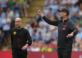 Liverpool's manager Jurgen Klopp, right, gives instructions from the side line as Manchester City's head coach Pep Guardiola looks on during the FA Community Shield soccer match between Liverpool and Manchester City at the King Power Stadium in Leicester, England, Saturday, July 30, 2022. (AP Photo/Frank Augstein)