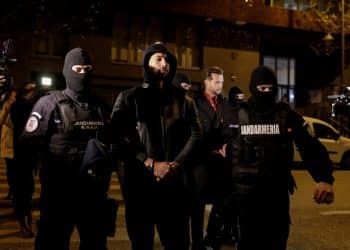 Andrew Tate and Tristan Tate are escorted by police officers outside the headquarters of the Directorate for Investigating Organized Crime and Terrorism in Bucharest (DIICOT) after being detained for 24 hours, in Bucharest, Romania, December 29, 2022.  Inquam Photos/Octav Ganea via REUTERS ATTENTION EDITORS - THIS IMAGE WAS PROVIDED BY A THIRD PARTY. ROMANIA OUT. NO COMMERCIAL OR EDITORIAL SALES IN ROMANIA     TPX IMAGES OF THE DAY