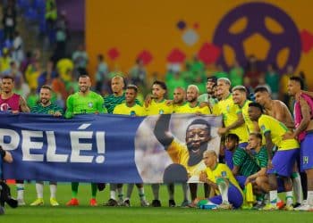 Brazil players stand behind a banner honouring Brazilian football legend Pele after they won the Qatar 2022 World Cup round of 16 football match between Brazil and South Korea at Stadium 974 in Doha on December 5, 2022. (Photo by Odd ANDERSEN / AFP)