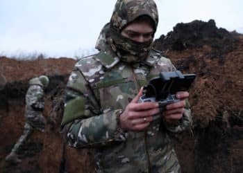 Two soldiers with the 58th Independent Motorized Infantry Brigade of the Ukrainian Army, who wanted to be identified as "Ghost", 24, and "Soap", 30, test fly a drone armed with a modified grenade, as Russia's invasion Ukraine continues, near Bakhmut, Ukraine, November 25, 2022. REUTERS/Leah Millis