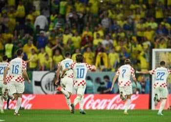 Soccer Football - FIFA World Cup Qatar 2022 - Quarter Final - Croatia v Brazil - Education City Stadium, Doha, Qatar - December 9, 2022 Croatia's Luka Modric, Bruno Petkovic and teammates celebrate after winning the penalty shootout progressing to the semi finals REUTERS/Dylan Martinez