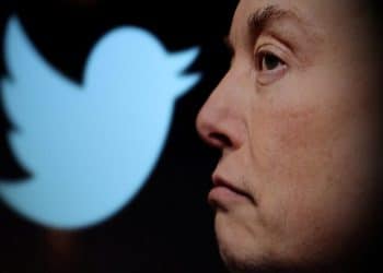 FILE PHOTO: Twitter logo and a photo of Elon Musk are displayed through magnifier in this illustration taken October 27, 2022. REUTERS/Dado Ruvic/Illustration/File Photo