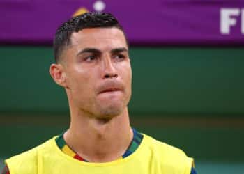 Soccer, 2022 World Cup in Qatar, Portugal - Switzerland, Round of 16, at Lusail Stadium, Portugal's Cristiano Ronaldo stands at the substitutes' bench during the national anthem.