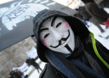 A protester wearing an Anonymous Guy Fawkes mask takes part in a demonstration against controversial Anti-Counterfeiting Trade Agreement (ACTA) as part of an international day of action against the increasingly-contested accord, in Budapest on February 11, 2012. Protesters have adopted as their own the now-iconic wryly smiling, mustachioed Guy Fawkes cartoon character masks of the global hacker group Anonymous. ACTA was signed last year in Tokyo, and aims to bolster international standards for intellectual property protection, for example by doing more to fight counterfeit medicine and other goods. But its attempt to attack illegal downloading and Internet file-sharing has sparked angry protests from users, who fear it could curtail online freedom.  AFP PHOTO / ATTILA KISBENEDEK (Photo by Attila KISBENEDEK / AFP)