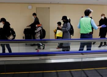 Passengers on a plane from China’s capital Beijing are guided to the coronavirus disease (COVID-19) test area upon their arrival at Narita international airport in Narita, east of Tokyo, Japan January 8, 2023. REUTERS/Kim Kyung-Hoon