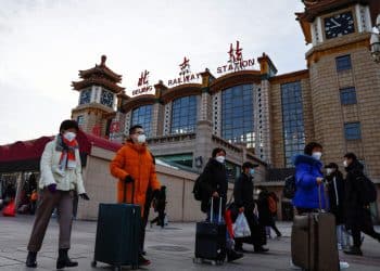 People walk outside Beijing Railway Station with their luggages as the annual Spring Festival travel rush starts, amid the coronavirus disease (COVID-19), ahead of the Chinese Lunar New Year, in Beijing, China January 7, 2023. REUTERS/Tingshu Wang