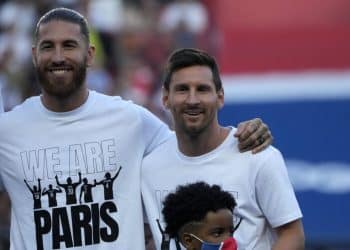 PSG's Lionel Messi, right, and PSG's Sergio Ramos smile during players presentation before the French League One soccer match between Paris Saint Germain and Strasbourg, at the Parc des Princes stadium in Paris, Saturday, Aug. 14, 2021. (AP Photo/Francois Mori)