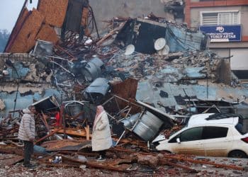 People look at rubble and damage following an earthquake in Hatay, Turkey, February 7, 2023. REUTERS/Umit Bektas