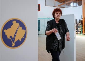 A Kosovo Albanian woman prepares to vote at a polling station in the village of Qabra, Kosovo, April 23, 2023. REUTERS/Valdrin Xhemaj NO RESALES. NO ARCHIVES.