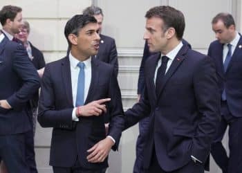 France's President Emmanuel Macron (R) speaks to Britain's Prime Minister Rishi Sunak (L) during the French-British summit, at the Elysee Palace, in Paris, on March 10, 2023. Britain's Prime Minister Rishi Sunak and France's President Emmanuel Macron are expected to adopt a new pact on cross-Channel illegal migration, as well as to vow more support for Ukraine and security in the Asia-Pacific region, Downing Street said. They will meet at the Elysee presidential palace for the first UK-French summit in five years, after Sunak became prime minister in October, following the stormy tenures of Liz Truss and Boris Johnson. (Photo by Kin Cheung / POOL / AFP)