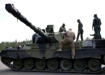 Soldiers stand on a tank at a training site, where Ukrainian soldiers undergo maintenance training on Leopard 1A5 tanks, at the German army Bundeswehr base, part of the EU Military Assistance Mission in support of Ukraine (EUMAM Ukraine) in Klietz, Germany, May 5, 2023. REUTERS/Nadja Wohlleben